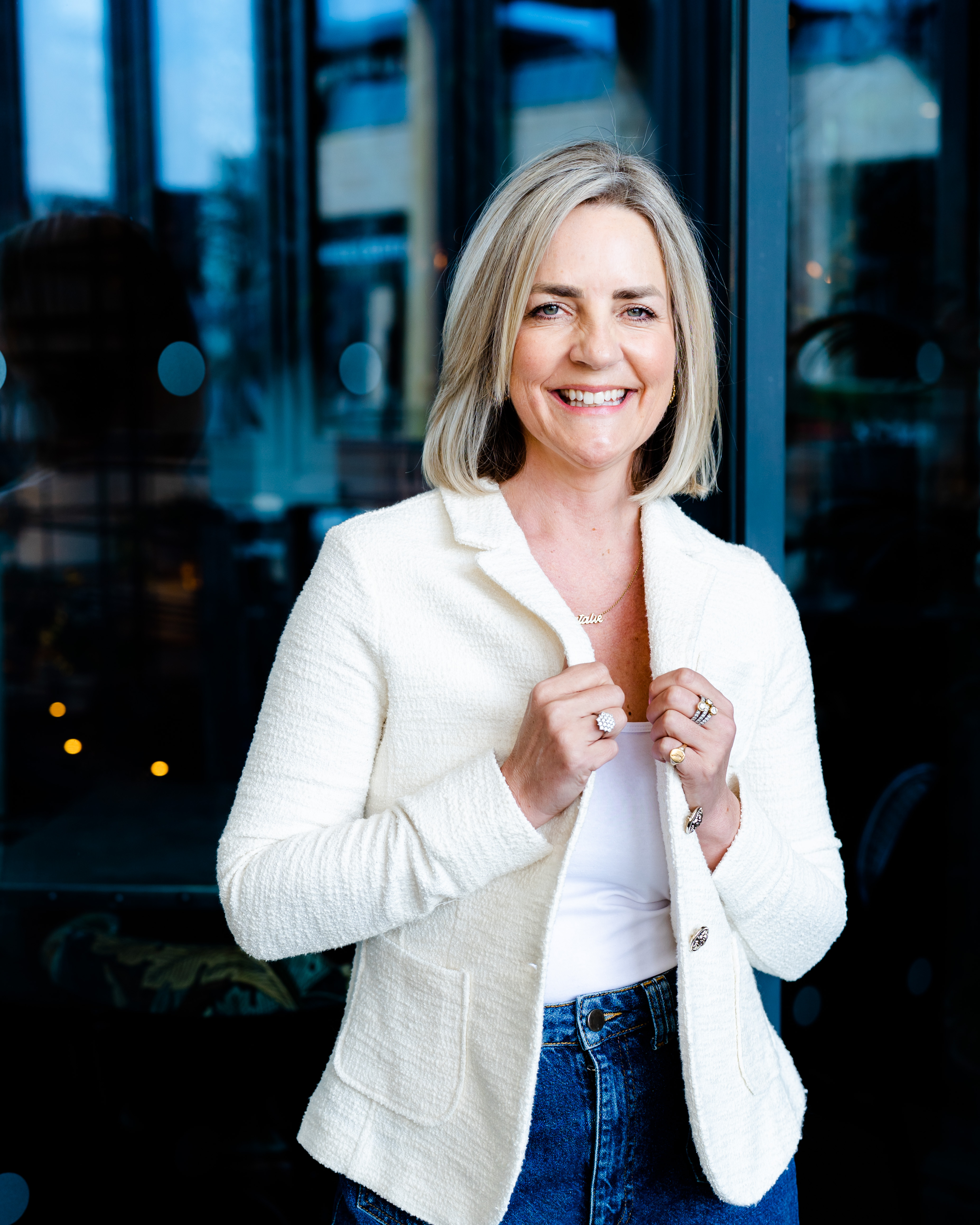Natalie Heeley in a white blazer, strong professional pose