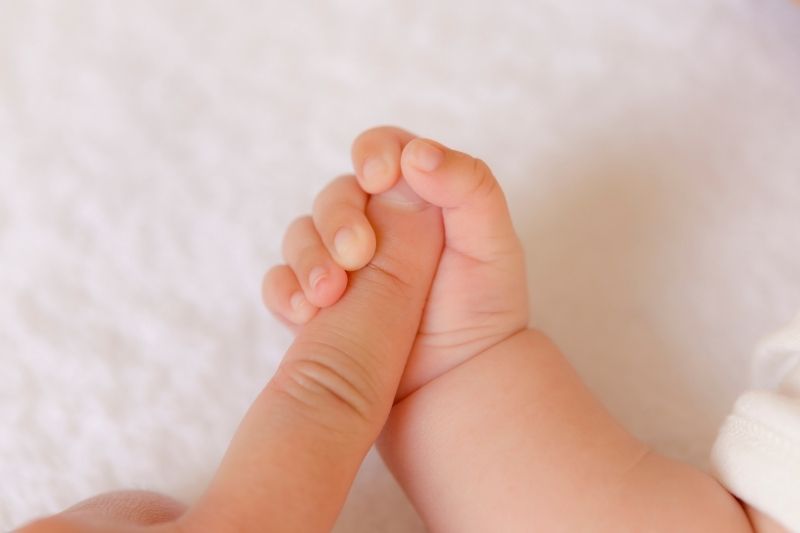 baby hand holding finger